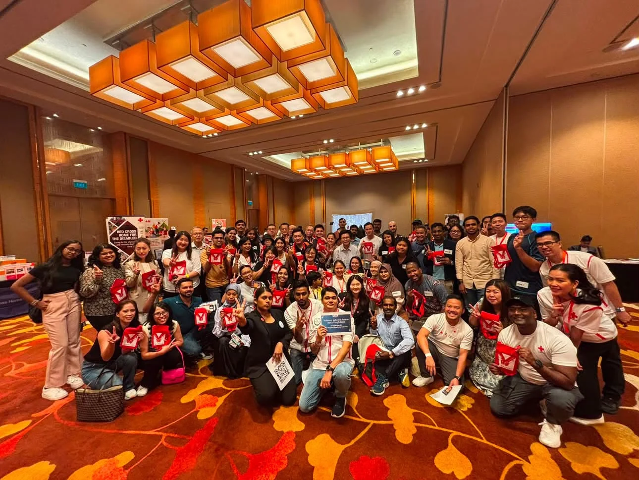 Community participants gathering for a group photograph at a Red Cross event