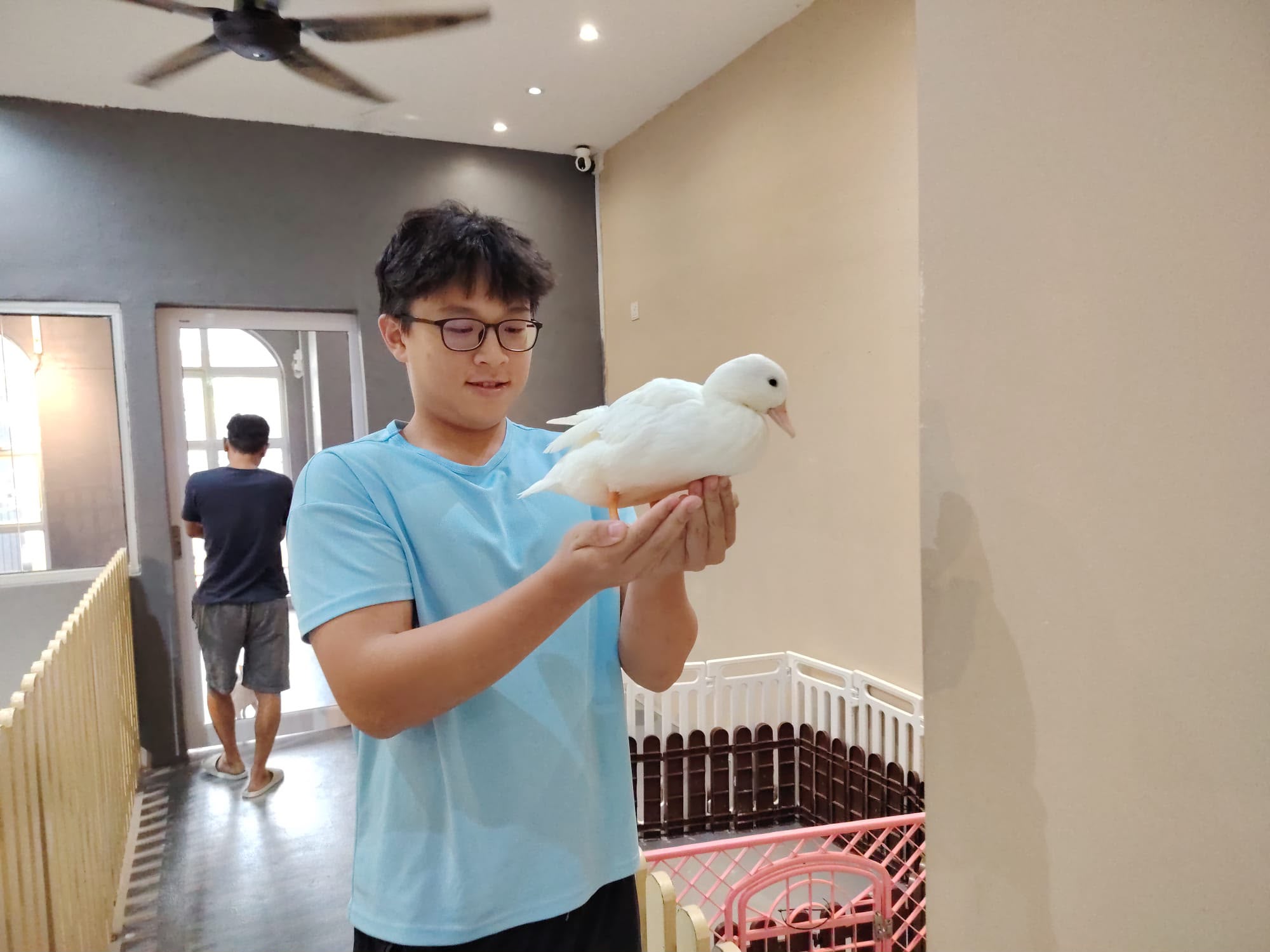 Low Cheng Jun holding a white duck