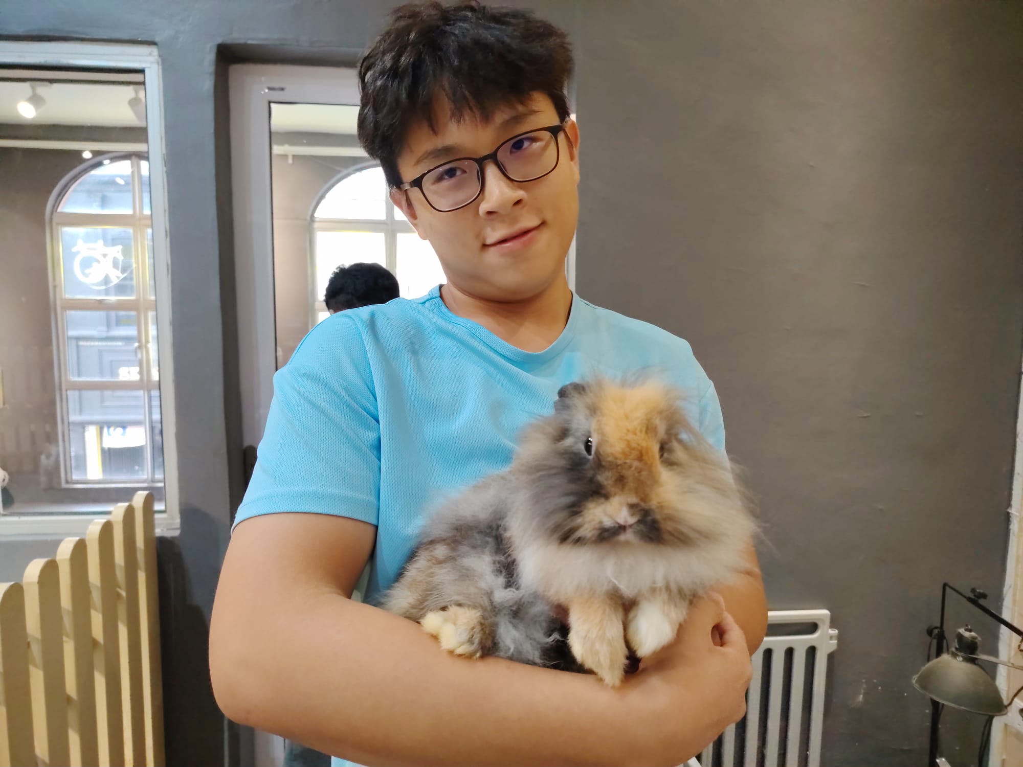 Low Cheng Jun holding two rabbits