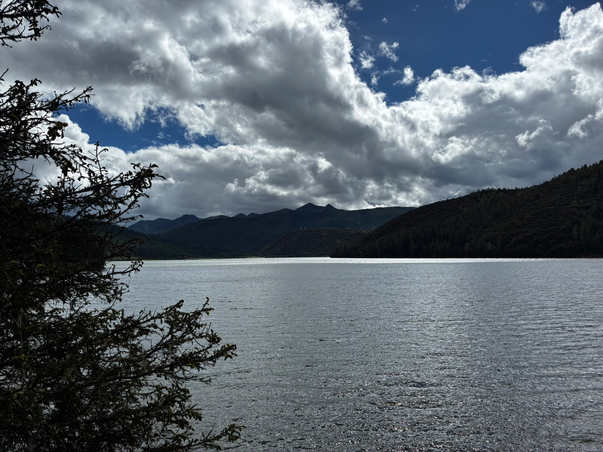 Mountain lake beneath cloud cover photographed by Low Cheng Jun